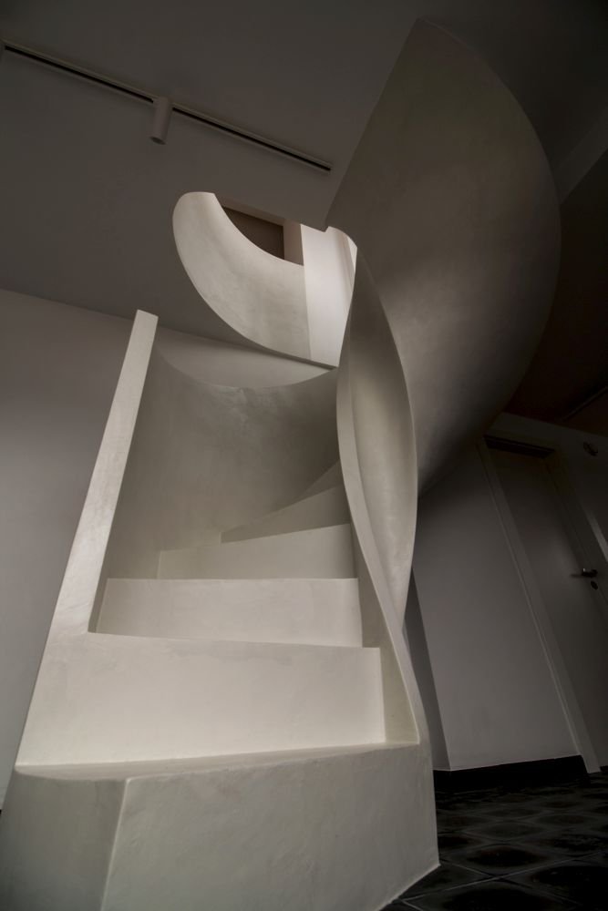 Betonová litá schodiště zpravidla vyžadují opravné úpravy povrchu, které se řeší stěrkou. Stěrka může však být použita na schodišti i k samotnému dekorování, jako například u tohoto bílého schodiště s moniérkou. Stěrkování schodiště vyžaduje precizní práci v hranách a velký smysl pro detail.