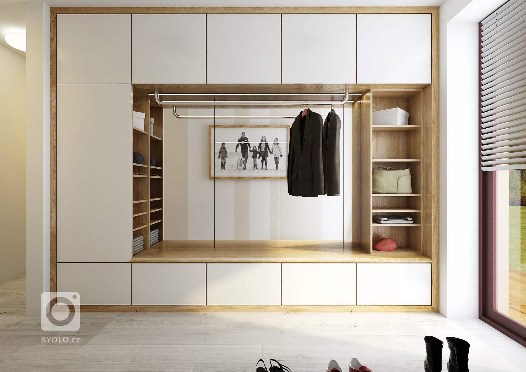 Návrh velkého společného prostoru s kuchyní a obývacím pokojem. Podlaha v šedém dřevodekoru je společná pro celý dům a jednotlivé místnosti se tak více spojují…