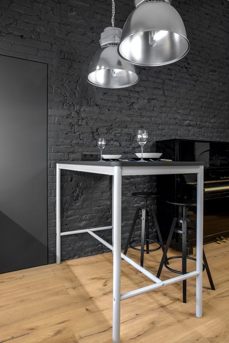 Byt s nábytkem IKEA a černou cihlovou zdí
