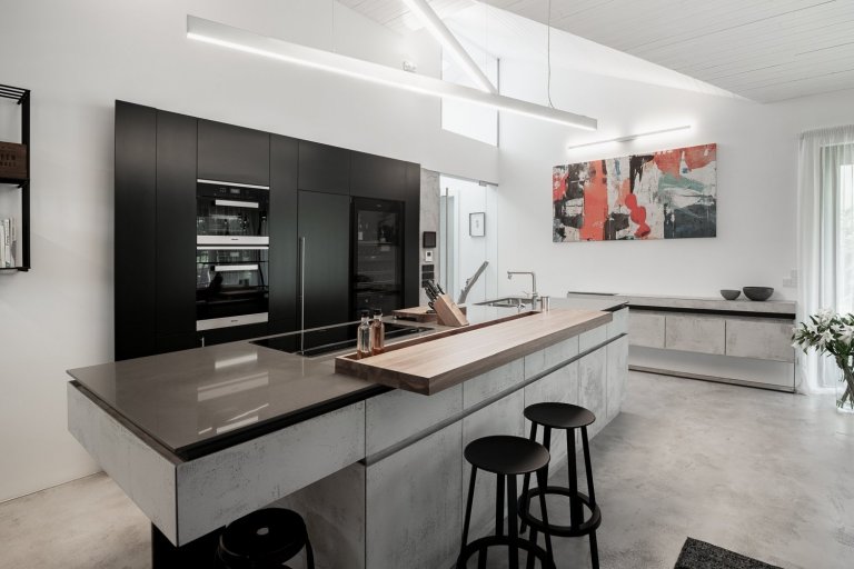 ovrchová úprava kuchyňské linky je betonová stěrka od Němce. Její odlehčený a přísný vzhled umocňují detaily v podobě zkosených hran u čel zásuvek. 